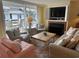 Comfortable living room with a fireplace, tv, and balcony overlooking the ocean at 671 Norris Dr., Pawleys Island, SC 29585