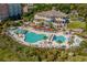 Aerial view of the resort's pool area, showcasing multiple pools, lounge chairs, lush landscaping, and building architecture at 6892 Belancino Blvd., Myrtle Beach, SC 29572