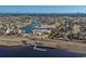 Expansive aerial view of a community with homes surrounding a lake, pool, and clubhouse at 6892 Belancino Blvd., Myrtle Beach, SC 29572