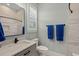 Neutral-toned bathroom with tiled shower, granite vanity and shuttered window at 6892 Belancino Blvd., Myrtle Beach, SC 29572