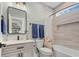 Full bathroom with tiled shower, granite vanity and flower-print shower curtain at 6892 Belancino Blvd., Myrtle Beach, SC 29572