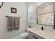 This bathroom features a single sink vanity with granite countertop and modern fixtures at 6892 Belancino Blvd., Myrtle Beach, SC 29572