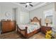 Cozy bedroom boasts a ceiling fan, dresser, and closet with bright natural light at 6892 Belancino Blvd., Myrtle Beach, SC 29572