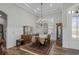 Formal dining room with beautiful wood floors, elegant chandelier, and classic wainscoting detail at 6892 Belancino Blvd., Myrtle Beach, SC 29572