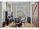 Bright dining room features hardwood floors, decorative furnishings, and modern chandelier lighting at 6892 Belancino Blvd., Myrtle Beach, SC 29572