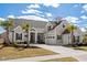 Beautiful exterior elevation of two-story home featuring a manicured lawn and palm trees at 6892 Belancino Blvd., Myrtle Beach, SC 29572