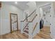 Hallway with a staircase, wood floors, wainscoting, and trim throughout at 6892 Belancino Blvd., Myrtle Beach, SC 29572