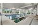 Bright indoor pool with ample natural light, featuring lane markers, and easy access steps at 6892 Belancino Blvd., Myrtle Beach, SC 29572