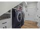 Modern laundry room with built in shelving and front-load machines at 6892 Belancino Blvd., Myrtle Beach, SC 29572