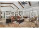 Spacious living room with vaulted ceiling, exposed beams, hardwood floors, and seamless flow to the kitchen at 6892 Belancino Blvd., Myrtle Beach, SC 29572