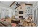 Open-concept living room with a brick fireplace, built-in shelving, and stylish furnishings at 6892 Belancino Blvd., Myrtle Beach, SC 29572