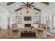 Inviting living room showcasing a brick fireplace, built-in shelving, and comfortable seating at 6892 Belancino Blvd., Myrtle Beach, SC 29572