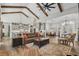 Spacious living room featuring exposed beams, a ceiling fan, and hardwood floors at 6892 Belancino Blvd., Myrtle Beach, SC 29572