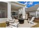 Outdoor patio featuring a fire pit, comfortable seating, a built in grill, and a tranquil backyard view at 6892 Belancino Blvd., Myrtle Beach, SC 29572