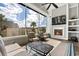Comfortable sunroom with fireplace and sliding glass doors at 6892 Belancino Blvd., Myrtle Beach, SC 29572