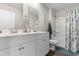 Bright bathroom featuring double vanity, and a bathtub with shower, offering a functional design at 706 Gryffindor Dr., Little River, SC 29566