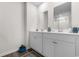 Modern bathroom featuring double sinks, white cabinets, and stylish decor at 706 Gryffindor Dr., Little River, SC 29566
