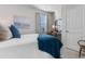 Bright bedroom featuring stylish decor, a cozy bed with blue accents, and a functional desk area at 706 Gryffindor Dr., Little River, SC 29566