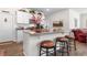 Open-concept kitchen featuring a granite island, bar stool seating, and ample counter space at 706 Gryffindor Dr., Little River, SC 29566