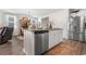 Bright kitchen with stainless steel appliances, island with granite countertops, and hardwood floors at 706 Gryffindor Dr., Little River, SC 29566