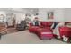 Spacious living room with a red sectional sofa and open floor plan to the kitchen and dining area at 706 Gryffindor Dr., Little River, SC 29566