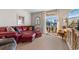 Comfortable living room with a plush red sofa, water view, and natural light at 706 Gryffindor Dr., Little River, SC 29566