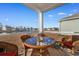 Covered patio boasts a stylish wicker table and chairs overlooking a beautiful water view at 706 Gryffindor Dr., Little River, SC 29566