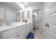 Bright bathroom with white vanity, framed artwork, and a view into the shower/tub area at 738 Harrison Mill St., Myrtle Beach, SC 29579