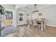 Bright dining room with a modern light fixture, wood flooring, and view of the lovely landscaped front yard at 738 Harrison Mill St., Myrtle Beach, SC 29579