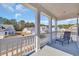 Inviting front porch with chair and view of the neighborhood homes on a sunny day at 738 Harrison Mill St., Myrtle Beach, SC 29579
