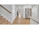 Hallway with wood flooring, stainless steel refrigerator, and white cabinetry, providing a seamless transition between spaces at 738 Harrison Mill St., Myrtle Beach, SC 29579