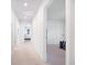 Bright hallway with neutral carpet flooring and white walls with open doorways to bedrooms at 738 Harrison Mill St., Myrtle Beach, SC 29579