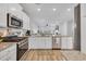 Modern kitchen with stainless steel appliances, granite countertops, wood flooring and open to the living area at 738 Harrison Mill St., Myrtle Beach, SC 29579