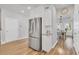 Contemporary kitchen showcasing stainless steel refrigerator, white cabinetry, granite countertops, and wood flooring at 738 Harrison Mill St., Myrtle Beach, SC 29579