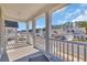 Covered porch with white railing, columns, a gray deck, and views of the neighborhood at 738 Harrison Mill St., Myrtle Beach, SC 29579