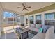 Comfortable screened-in porch with ceiling fan, plush seating, and cozy fire table at 738 Harrison Mill St., Myrtle Beach, SC 29579
