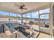 Relaxing screened-in porch features a cushioned seating area and a cozy fire table at 738 Harrison Mill St., Myrtle Beach, SC 29579