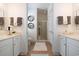 Elegant bathroom with double vanities, marble countertops, and a glass-enclosed shower at 768 Satterwhite Way, Myrtle Beach, SC 29577