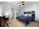 Stylish bedroom with a dark wood headboard, ceiling fan, desk and chair at 768 Satterwhite Way, Myrtle Beach, SC 29577