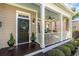 Inviting covered porch with a welcome wreath, ceiling fan, and outdoor seating at 768 Satterwhite Way, Myrtle Beach, SC 29577