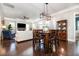 Open-concept living room featuring hardwood floors, a dining table, and a cozy fireplace at 768 Satterwhite Way, Myrtle Beach, SC 29577