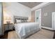 Spacious main bedroom with a decorative accent wall, a king bed, and ensuite bathroom at 768 Satterwhite Way, Myrtle Beach, SC 29577