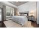 Elegant bedroom with a tray ceiling, decorative headboard, and large windows at 768 Satterwhite Way, Myrtle Beach, SC 29577
