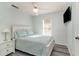 Cozy bedroom featuring a queen-size bed, light blue walls, a ceiling fan, and a wall-mounted television at 813 Starboard Ct., Murrells Inlet, SC 29576