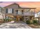 Charming beach home with stilt foundation, covered porch, and driveway at 813 Starboard Ct., Murrells Inlet, SC 29576