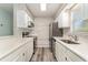 Modern kitchen with white cabinets, stainless steel appliances, and quartz countertops at 813 Starboard Ct., Murrells Inlet, SC 29576