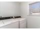 Bright laundry room with a window and side-by-side washer and dryer at 813 Starboard Ct., Murrells Inlet, SC 29576