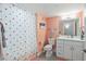 Cheerful bathroom with colorful polka dot shower curtain, peach walls, and white vanity at 8560 Queensway Blvd. # 1206, Myrtle Beach, SC 29572
