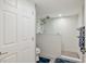 Bathroom featuring a glass-enclosed shower with textured tile, dual shower heads and blue mats at 8560 Queensway Blvd. # 1206, Myrtle Beach, SC 29572