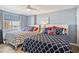 Comfortable bedroom with two beds, light blue walls, ceiling fan, and scenic window view at 8560 Queensway Blvd. # 1206, Myrtle Beach, SC 29572